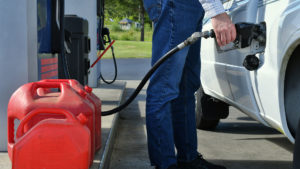 Man filling up his car with gasoline.